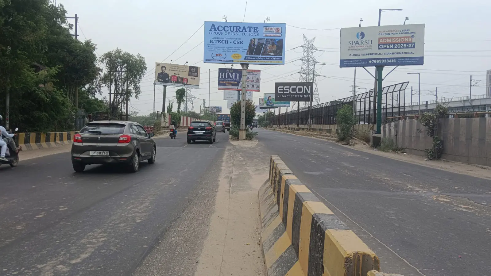 A run of Adelite Media hoardings along a Delhi NCR expressway